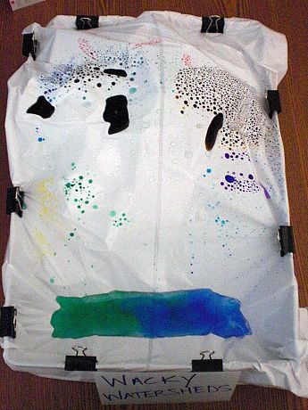 Spray your watershed with water to demonstrate how water flows over land into streams and rivers, picking up various particles along the way, and eventually collects into a larger body of water. (Image credit: Claire Sargo)